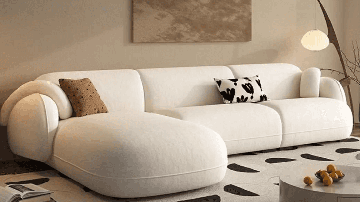 A sectional sofa with a cream-colored fabric upholstery. It features rounded arms and a low profile.… — free OBJ 3D model