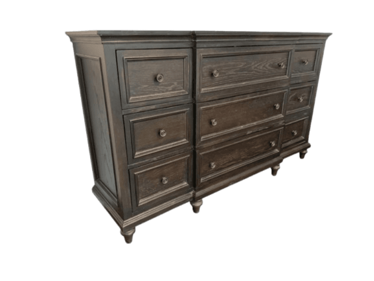 A long, dark-stained wooden dresser featuring a classic transitional design. It has a total of nine drawers, with three larger, horizontal drawers in the center stack and two vertical stacks of three smaller drawers on each side. The drawer fronts feature framed panel detailing, and all drawers are equipped with round, dark knob pulls. The dresser stands on short, turned bun feet and has a slightly overhanging top with a subtle crown molding detail. — 3D model