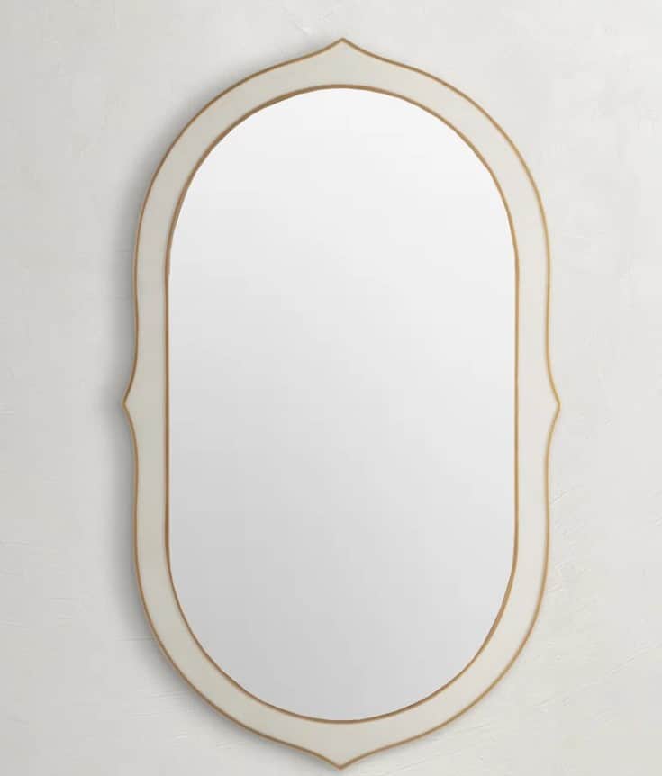 An oval-shaped mirror with a decorative frame. The frame has a smooth, matte finish with a subtle cu… — 3D model