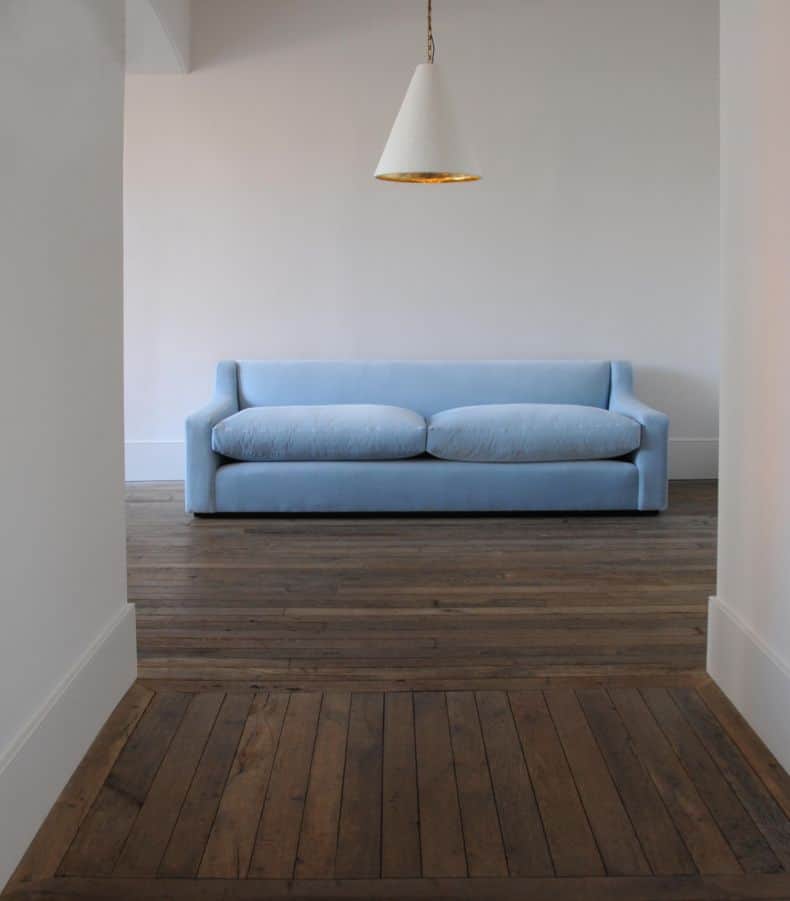 A contemporary two-seater sofa upholstered in a light blue fabric. It features a streamlined design… — 3D model