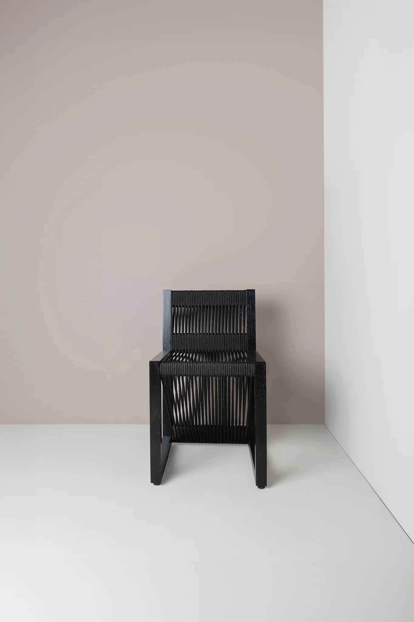 A contemporary chair with a black frame and a seat and backrest constructed from closely spaced blac… — 3D model
