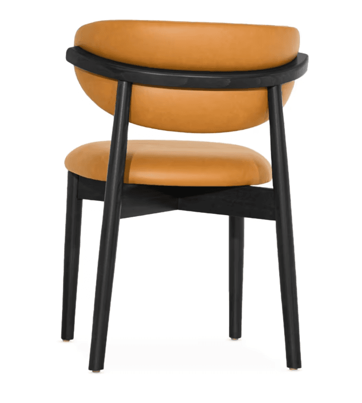 A contemporary dining chair featuring an ebonized wooden frame and tan leather upholstery. The chair has a distinct curved backrest supported by a wooden rail, and a cushioned seat. The legs are slender and cylindrical, suggesting a minimalist and modern aesthetic. — 3D model