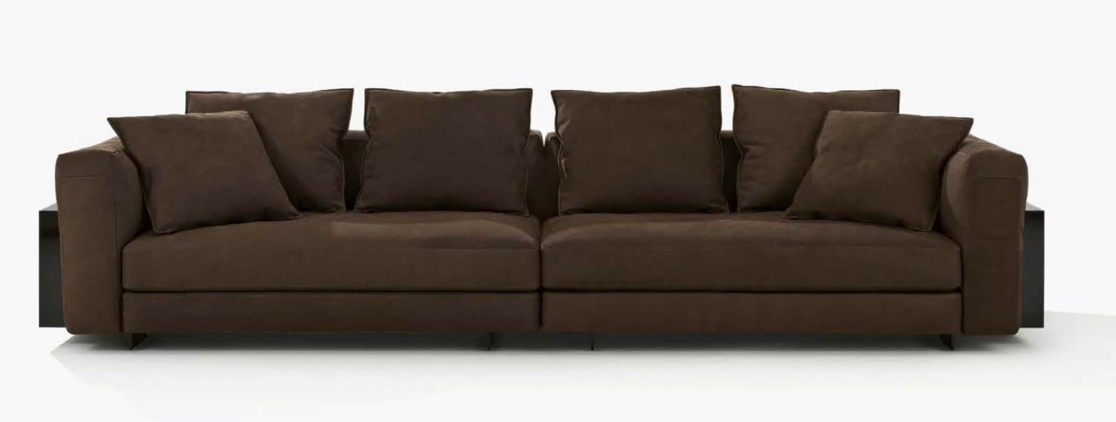 A modular sofa with a deep seat and plush cushions, upholstered in a dark brown fabric. The design f… — free GLTF 3D model
