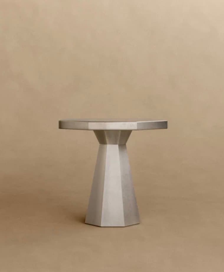 A contemporary octagonal table with a faceted pedestal base, rendered in a uniform grey finish, likely metal or a composite material. — 3D model