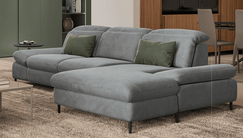 An L-shaped contemporary sectional sofa upholstered in light grey fabric, featuring adjustable headrests on multiple seating units. The sofa includes an extended chaise-like section on one end and is supported by discreet, low-profile dark metal legs. Two olive green accent pillows are placed on the sofa. — 3D model