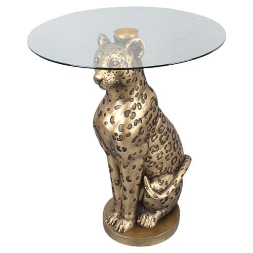 A decorative side or accent table featuring a detailed, seated leopard sculpture as its base, supporting a round, clear glass tabletop. The leopard base is finished in a metallic bronze or brass tone. — 3D model