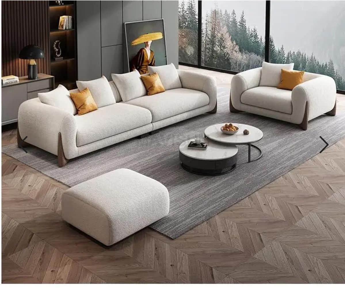 A contemporary modular sofa composed of two sections, upholstered in a cream/off-white bouclé fabric… — free BLEND 3D model