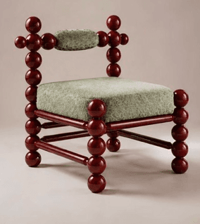 A unique postmodern accent chair featuring a frame constructed from numerous spherical, dark red lacquered wood elements. The seat and small backrest are upholstered in a light green textured fabric. — 3D model