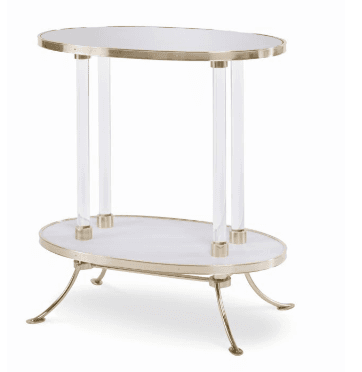 A two-tiered oval accent table featuring a brass-finished metal frame and clear acrylic support columns. Both tiers have white oval surfaces, possibly a faux marble or laminate, encased in brass rims. The table stands on four splayed brass legs with curved feet, extending from the lower tier. — 3D model