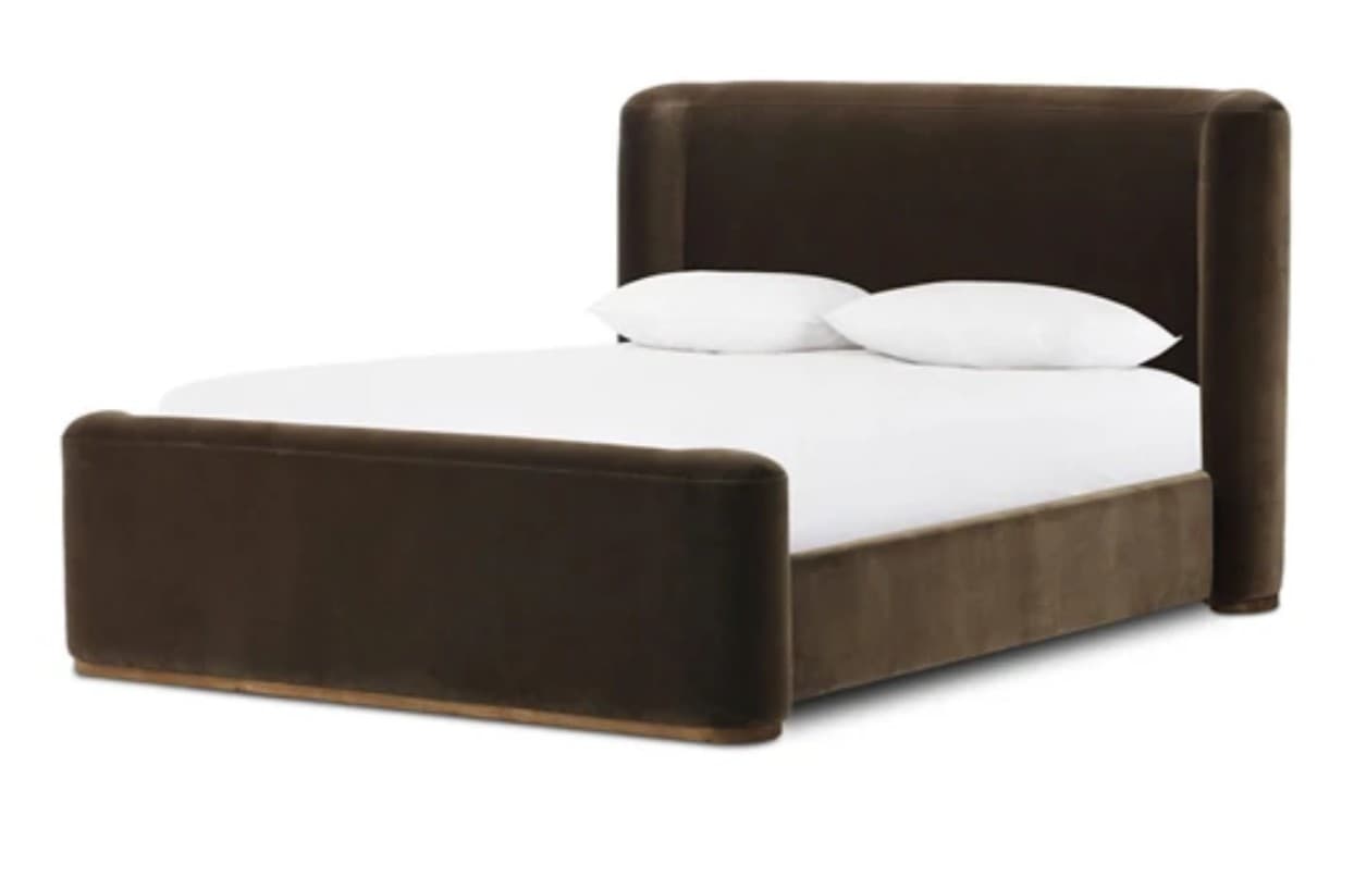 A contemporary platform bed featuring dark brown velvet upholstery across the entire frame, including the headboard and footboard. Both the headboard and footboard exhibit prominent rounded corners, creating a soft and inviting aesthetic. The headboard is tall and subtly angled, while the footboard is lower and echoes the rounded form. The bed base is low-profile, and it is shown with white bedding and two white pillows. — 3D model