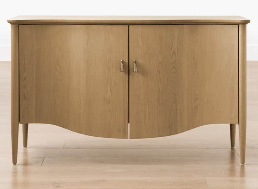 A wooden cabinet with two doors, featuring a curved bottom edge and four tapered legs. The doors hav… — 3D model