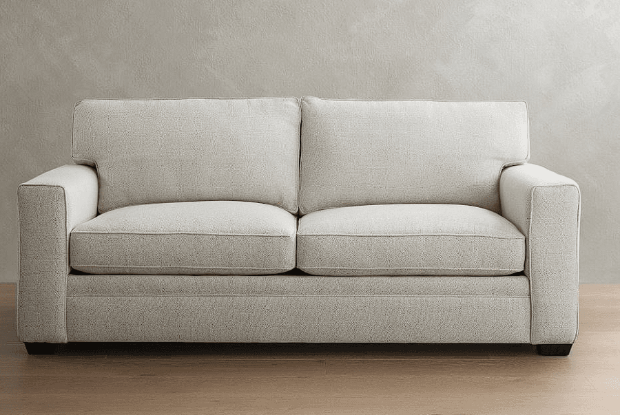 A contemporary upholstered two-seater sofa, commonly known as a loveseat, featuring square track arms and tailored lines. It is upholstered in a light-colored, textured fabric with visible piping detail on the two seat cushions and two loose back cushions. The sofa is supported by short, dark-stained block legs. — 3D model