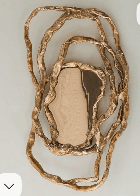 An ornate mirror with a frame resembling organic, intertwined branches or roots. The reflective surf… — 3D model