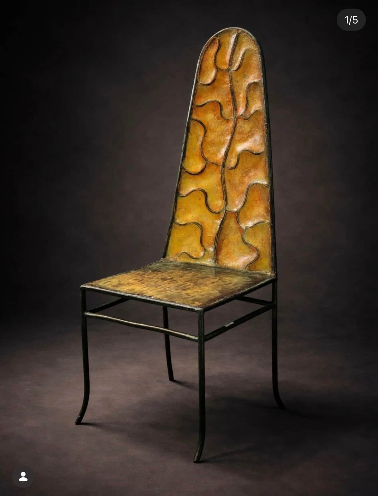 A single, tall-backed chair featuring a dark metal frame and a patinated metal seat and backrest wit… — 3D model