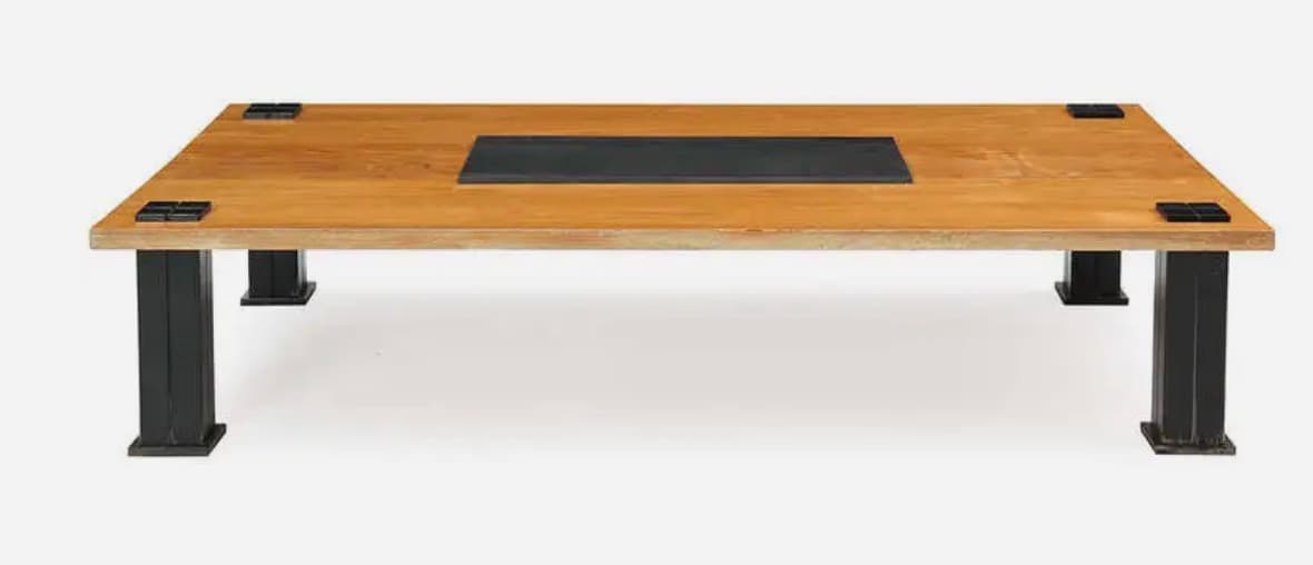 A rectangular coffee table featuring a light-toned wooden top with a central, recessed black inlay. The table is supported by four robust, square-sectioned black metal legs, which are visibly attached to the tabletop with square black metal corner brackets. — 3D model