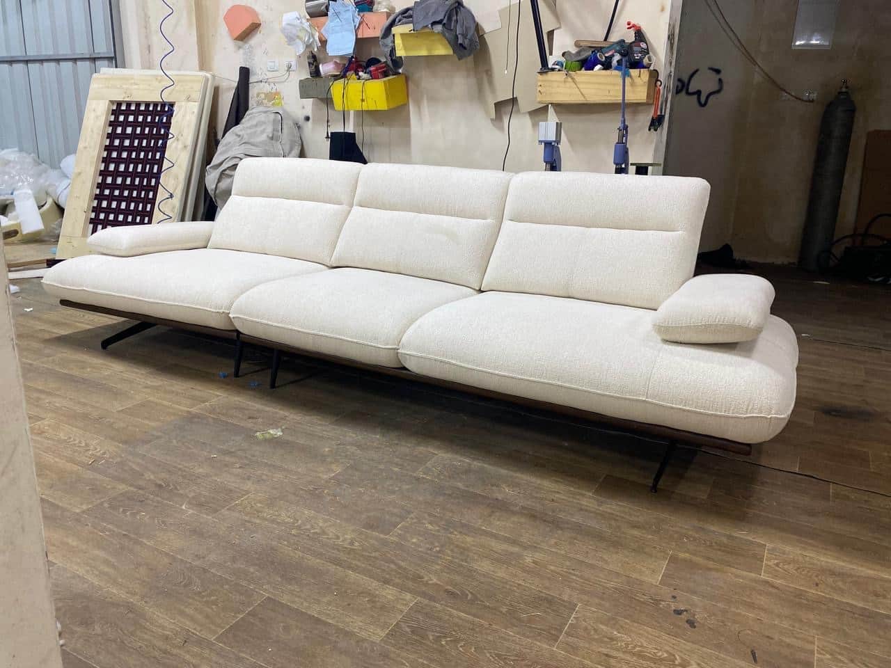 A modern, sectional sofa with a cream-colored textured fabric upholstery. It features a low profile… — 3D model