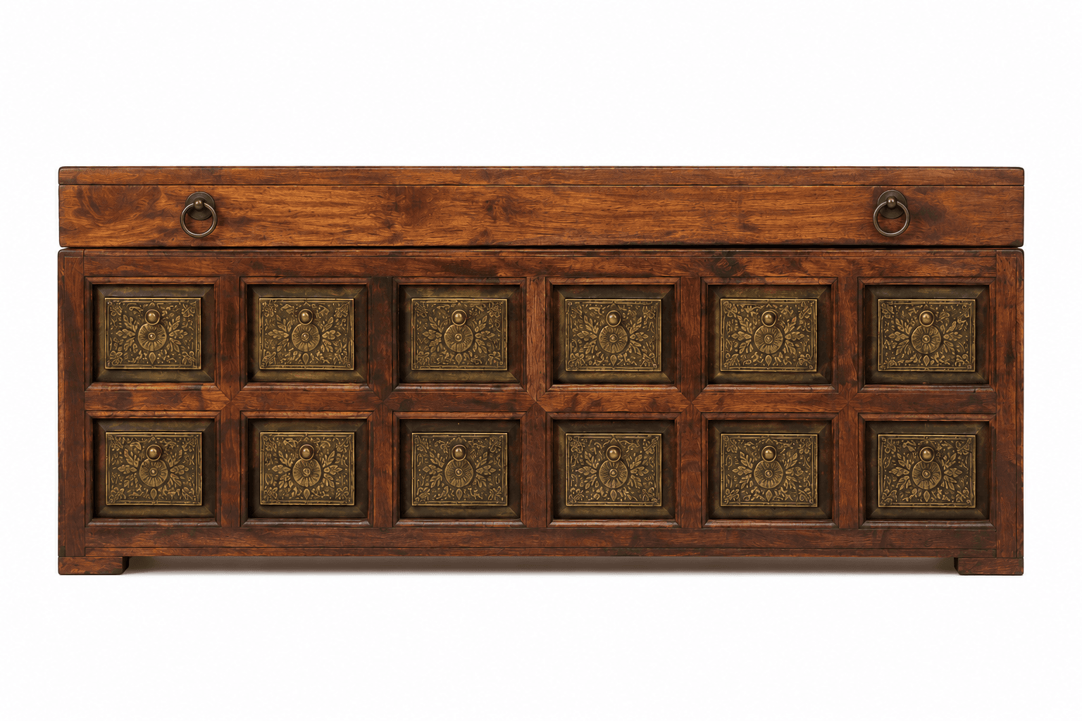 A rectangular, dark-stained wooden chest featuring a lift-top lid and decorative embossed brass panels on the front and sides. The lid is equipped with two brass ring pulls. The front facade displays twelve square brass panels arranged in a grid pattern, each with an intricate, symmetrical design. The chest rests on a short, integrated plinth base. — 3D model