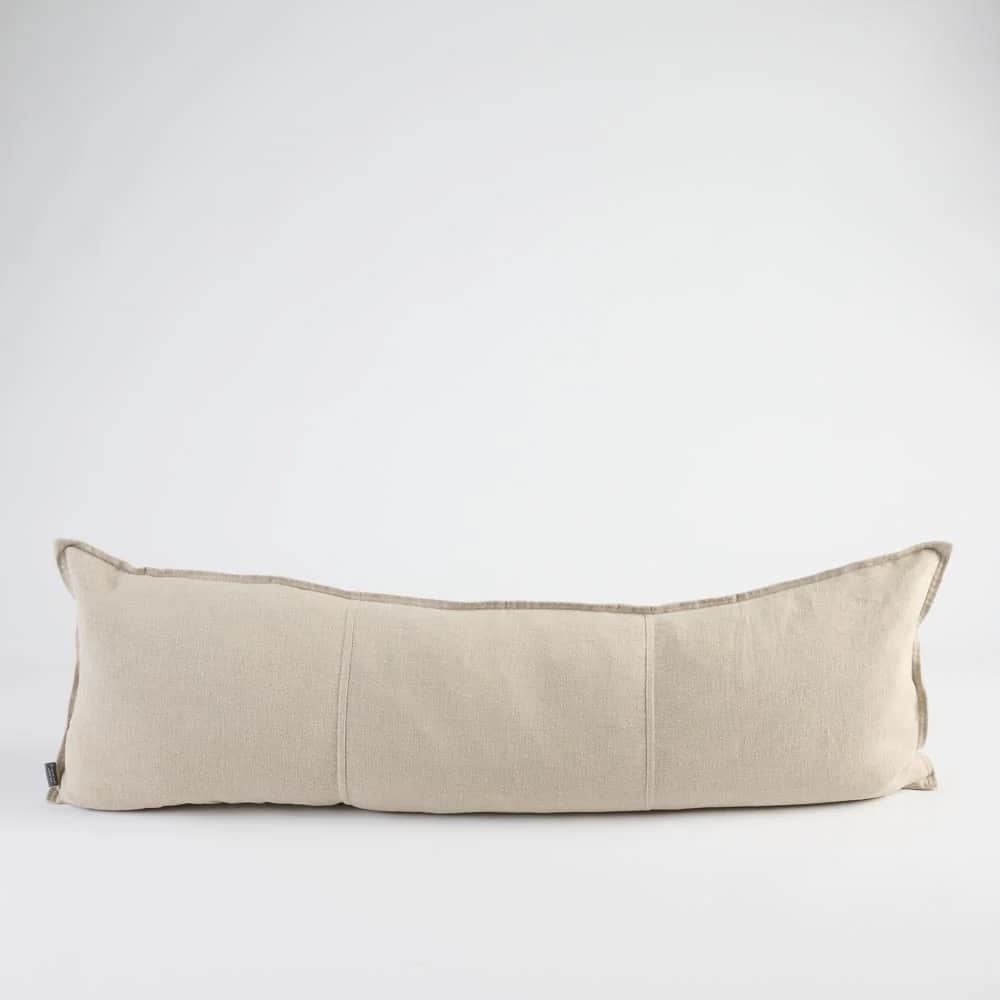 A long, rectangular bolster pillow made from a light beige woven fabric, featuring piped edges and s… — 3D model