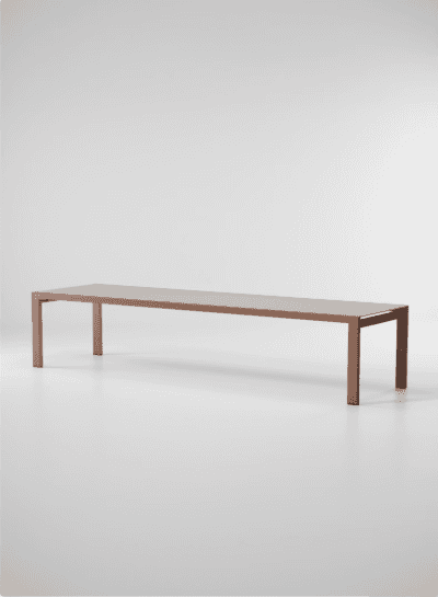 A long, minimalist rectangular coffee table featuring a slim profile. The table consists of a reddis… — 3D model