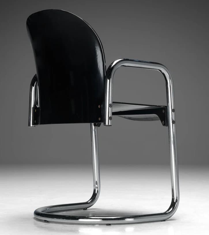 A cantilever armchair with a curved black seat and back, supported by a chrome-plated tubular steel frame. The frame forms a continuous loop for the base and extends upwards to create armrests and supports for the seat and back. The seat and back appear to be made of molded plastic or a similar material. — 3D model