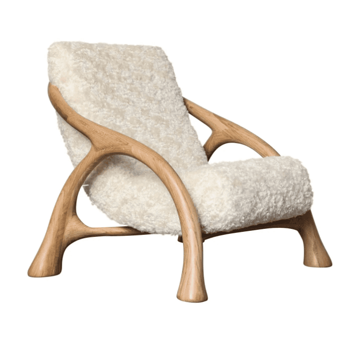 A sculptural armchair featuring a curved, organic wooden frame reminiscent of tree branches, support… — 3D model
