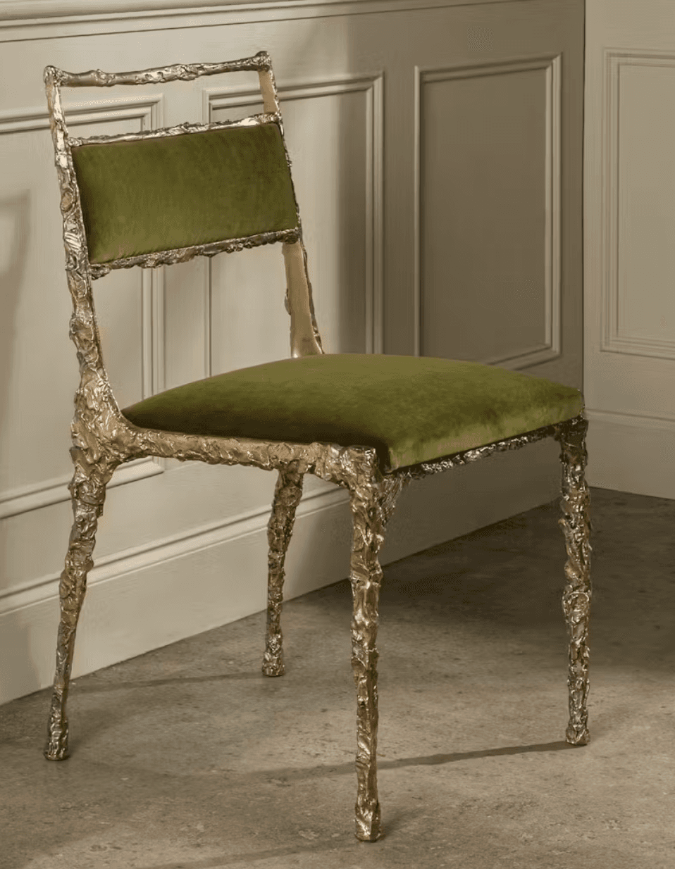 An armless side chair featuring a highly textured, organic silver cast metal frame and olive green velvet upholstery on the seat and backrest. — 3D model