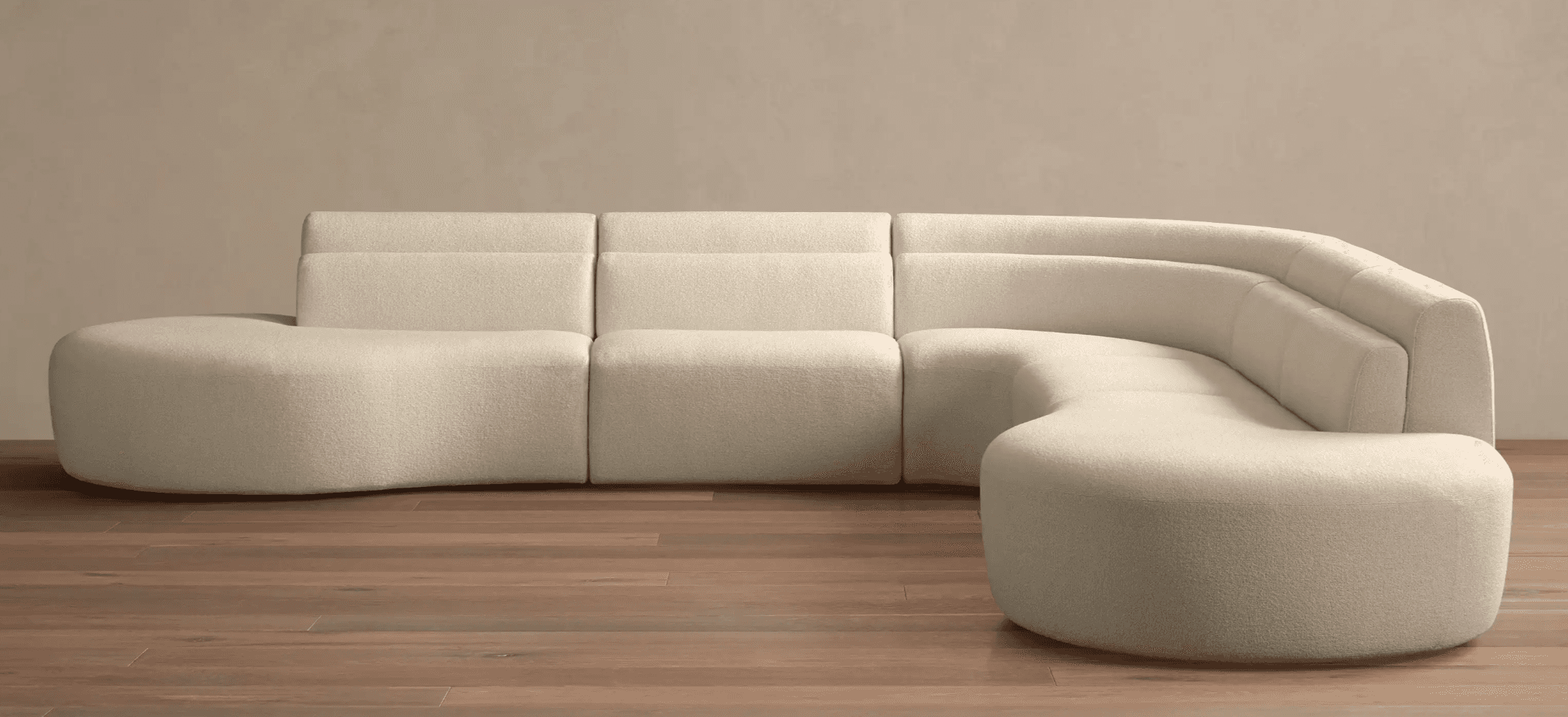 A modular sectional sofa with a curved, organic design. It is upholstered in a textured fabric and c… — free BLEND 3D model