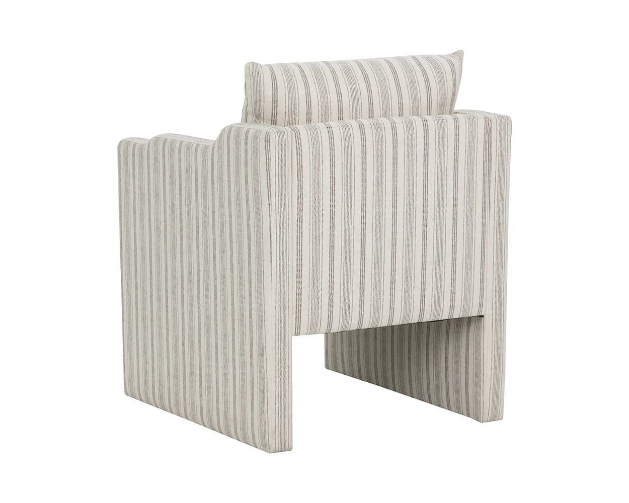 A contemporary armchair with a geometric silhouette, upholstered in a striped fabric. The armchair features a low profile with integrated armrests and a backrest that extends upwards. A separate, plush cushion is placed at the top of the backrest, providing additional head support. The base of the chair is constructed with solid, block-like legs that create an open space beneath the seat. — 3D model