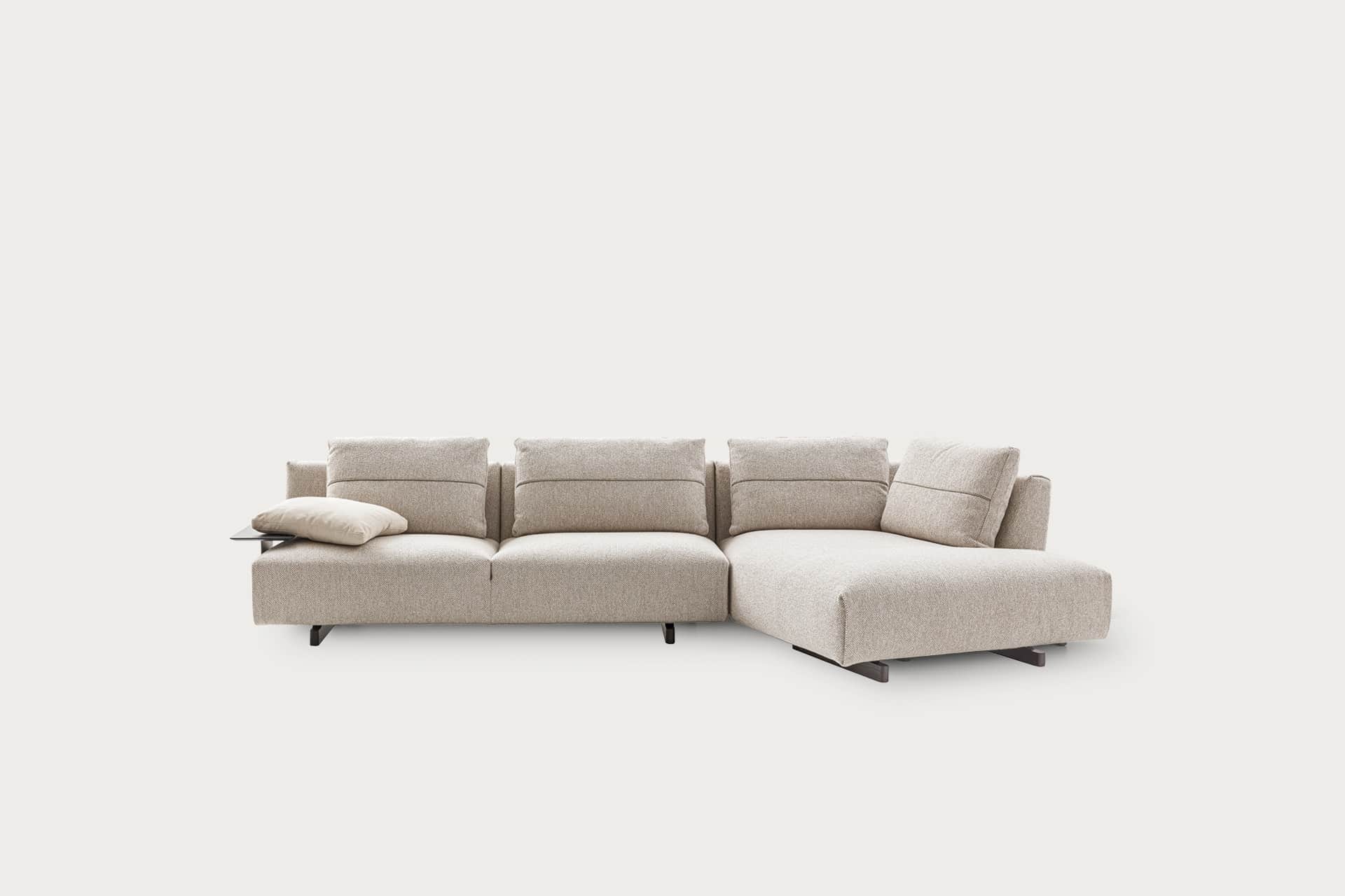 A contemporary modular sectional sofa featuring a chaise lounge component and an integrated side tab… — 3D model