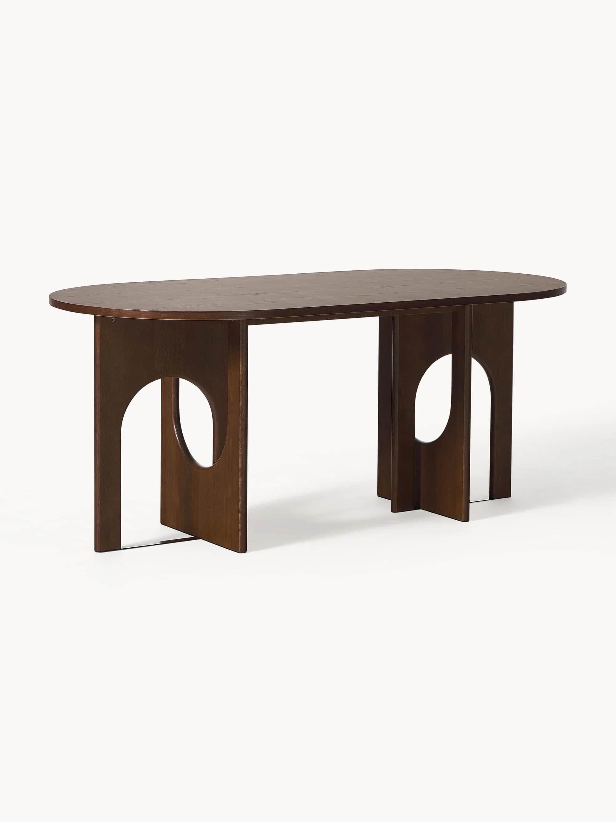 An oval-shaped dining table with a dark wood finish. The table features a thick, solid tabletop and… — 3D model