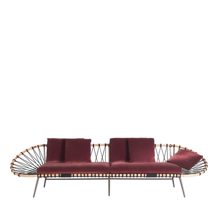 A contemporary sofa featuring a distinctive design with a woven backrest and armrest on one side, an… — 3D model