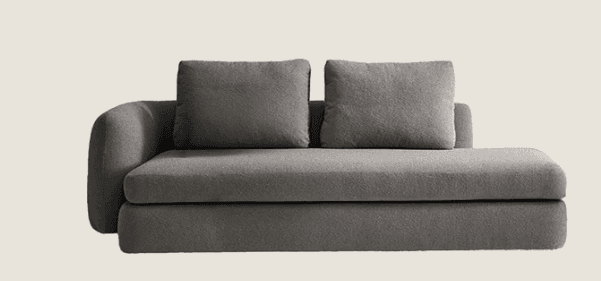 A contemporary modular chaise lounge sofa section upholstered in a textured grey fabric. It features a single rounded armrest on the left, an extended seat for lounging, and two loose back cushions. The design is minimalist with a low-profile silhouette. — 3D model