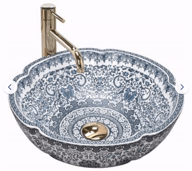 A decorative round ceramic vessel sink featuring an intricate blue and white chinoiserie pattern and a scalloped rim, paired with a tall, matte brass single-handle faucet. — 3D model