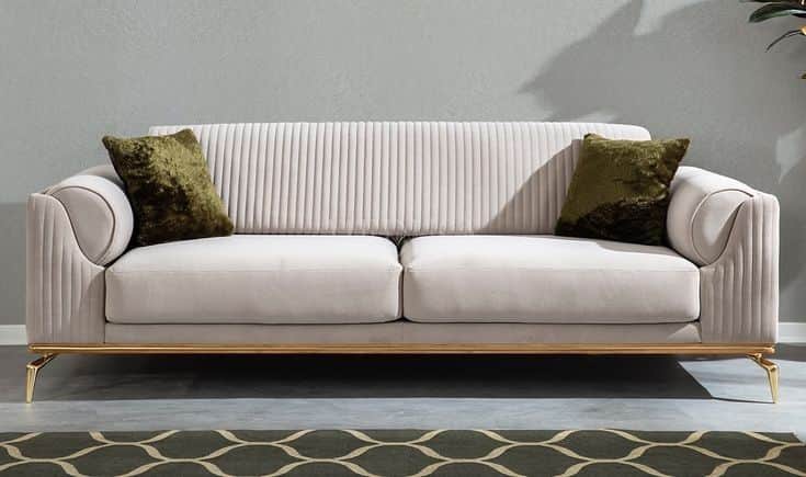 A modern three-seater sofa featuring plush light-colored upholstery, likely cream or off-white, with… — free OBJ 3D model