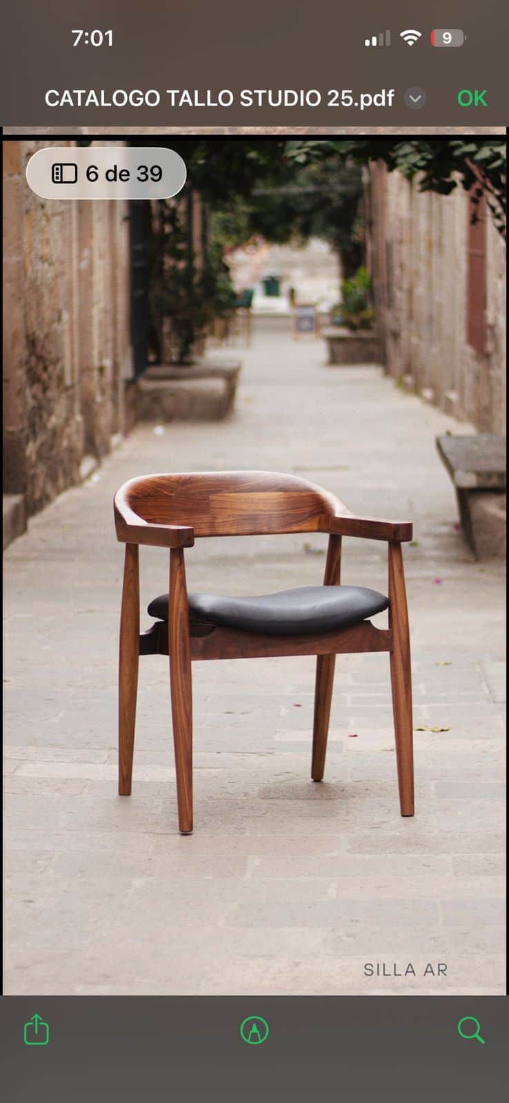 A modern armchair with a curved wooden frame and a dark upholstered seat. The chair has a solid wood… — free OBJ 3D model
