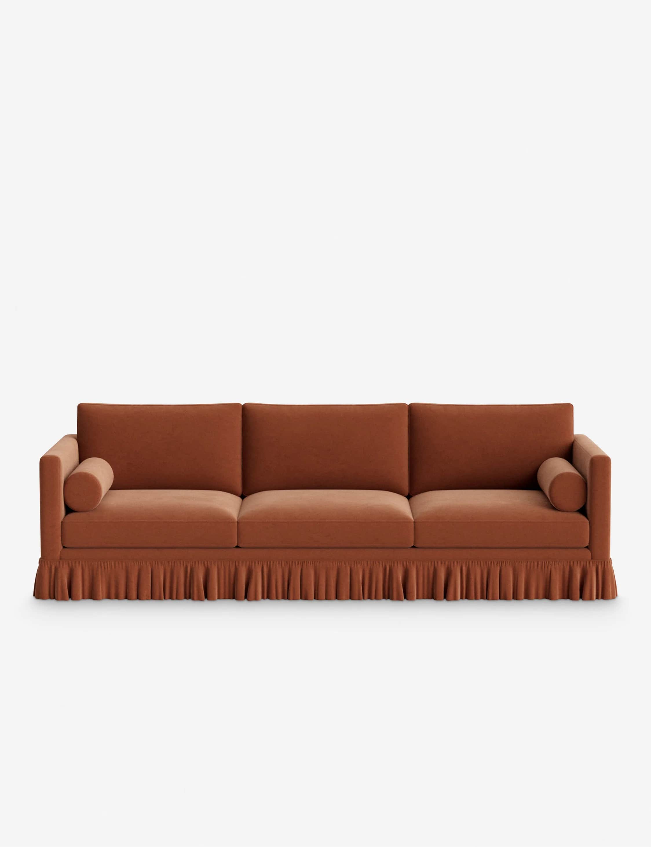 A long, three-seater sofa upholstered in a warm, burnt orange velvet fabric. It features a full, ple… — 3D model