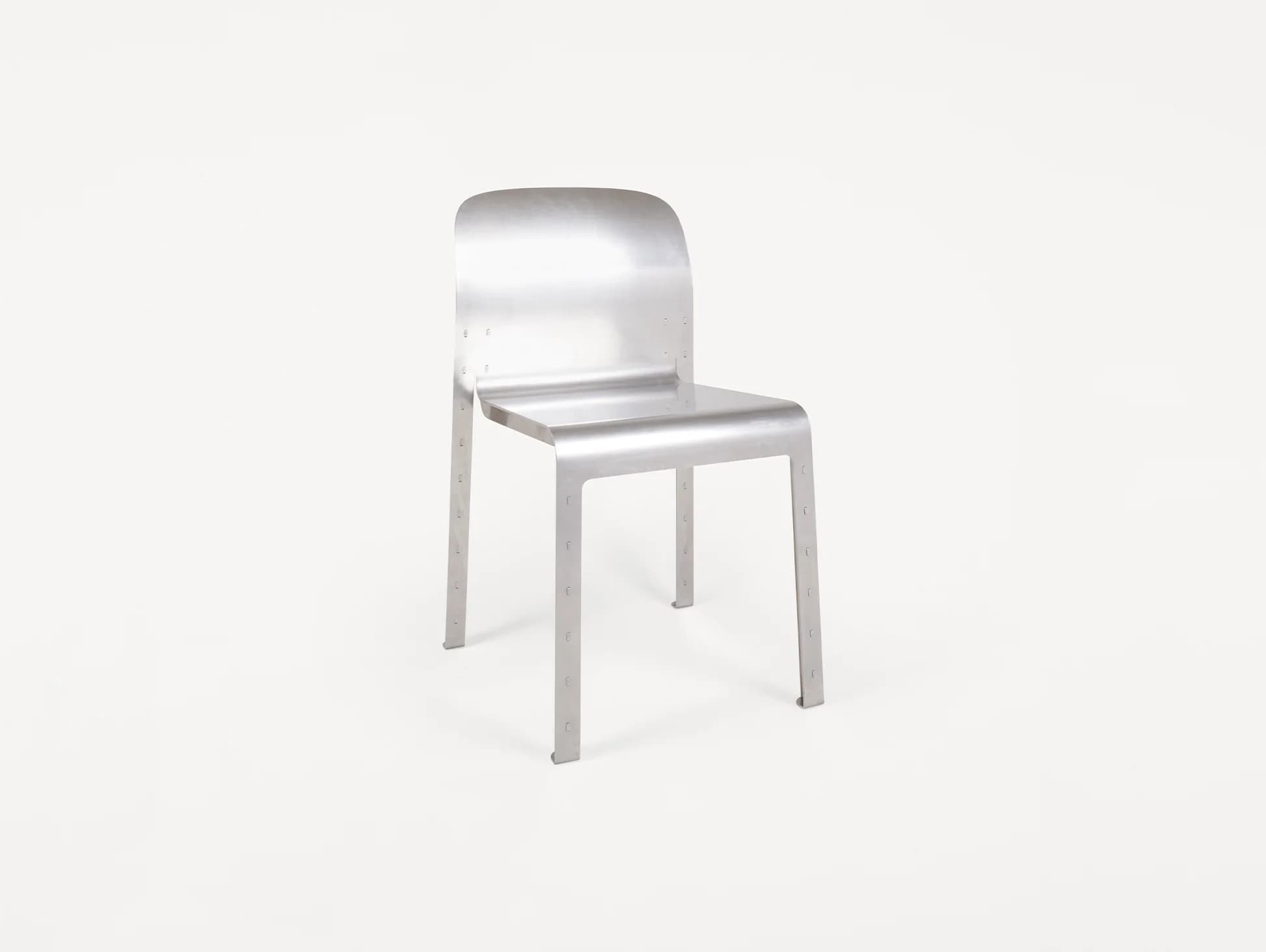 A minimalist, industrial-style chair constructed from brushed aluminum, featuring a seamlessly curved backrest and seat, and four sturdy, straight legs with visible rivet details. — 3D model