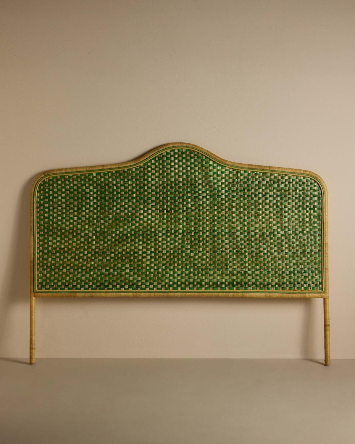 A headboard featuring a natural light wood or rattan frame with an irregularly curved top edge, encompassing a vibrant green woven cane panel. It is supported by two integrated vertical posts. — 3D model