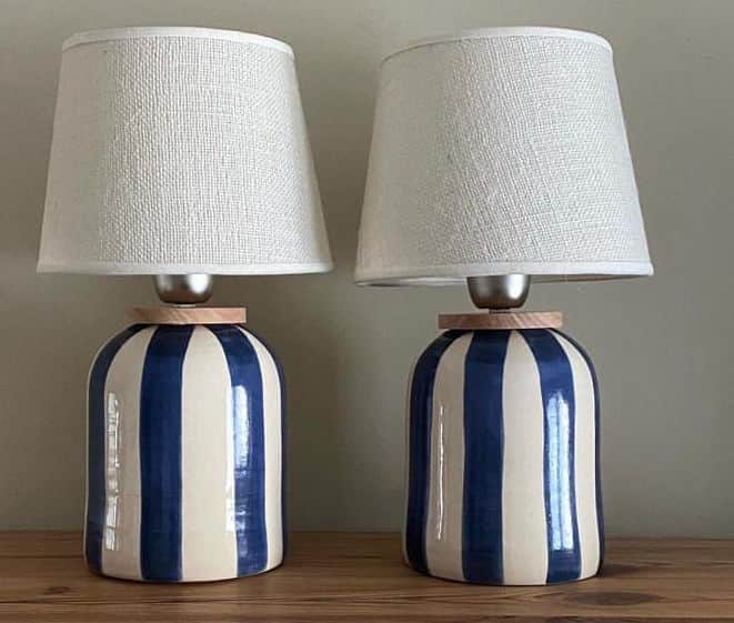 A table lamp featuring a cylindrical ceramic base with a bold blue and white vertical stripe pattern… — free OBJ 3D model