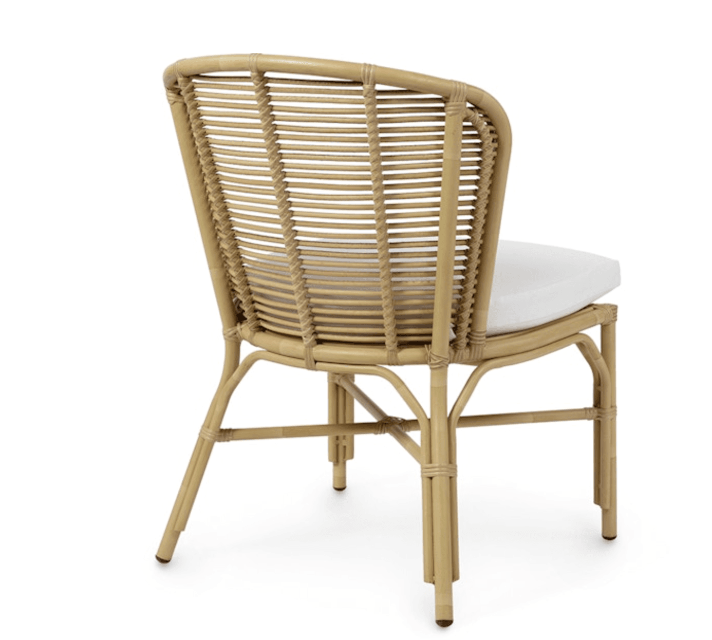 A natural rattan dining chair featuring a curved, woven backrest and a solid frame construction. The seat is fitted with a removable white upholstered cushion. The chair's frame utilizes bent rattan poles, with smaller rattan strands woven to form the backrest, showcasing traditional craftsmanship. The design is lightweight and suitable for various casual or tropical-inspired settings. — 3D model