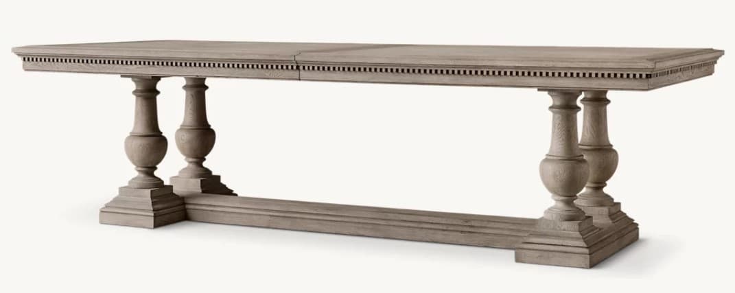 A rectangular dining table with a weathered gray finish, featuring a thick, segmented tabletop and a substantial base. The base consists of two turned baluster-style legs connected by a stretcher. The legs are supported by tiered, stepped bases. The apron of the tabletop is adorned with a decorative frieze of small, regularly spaced rectangular indentations. — 3D model