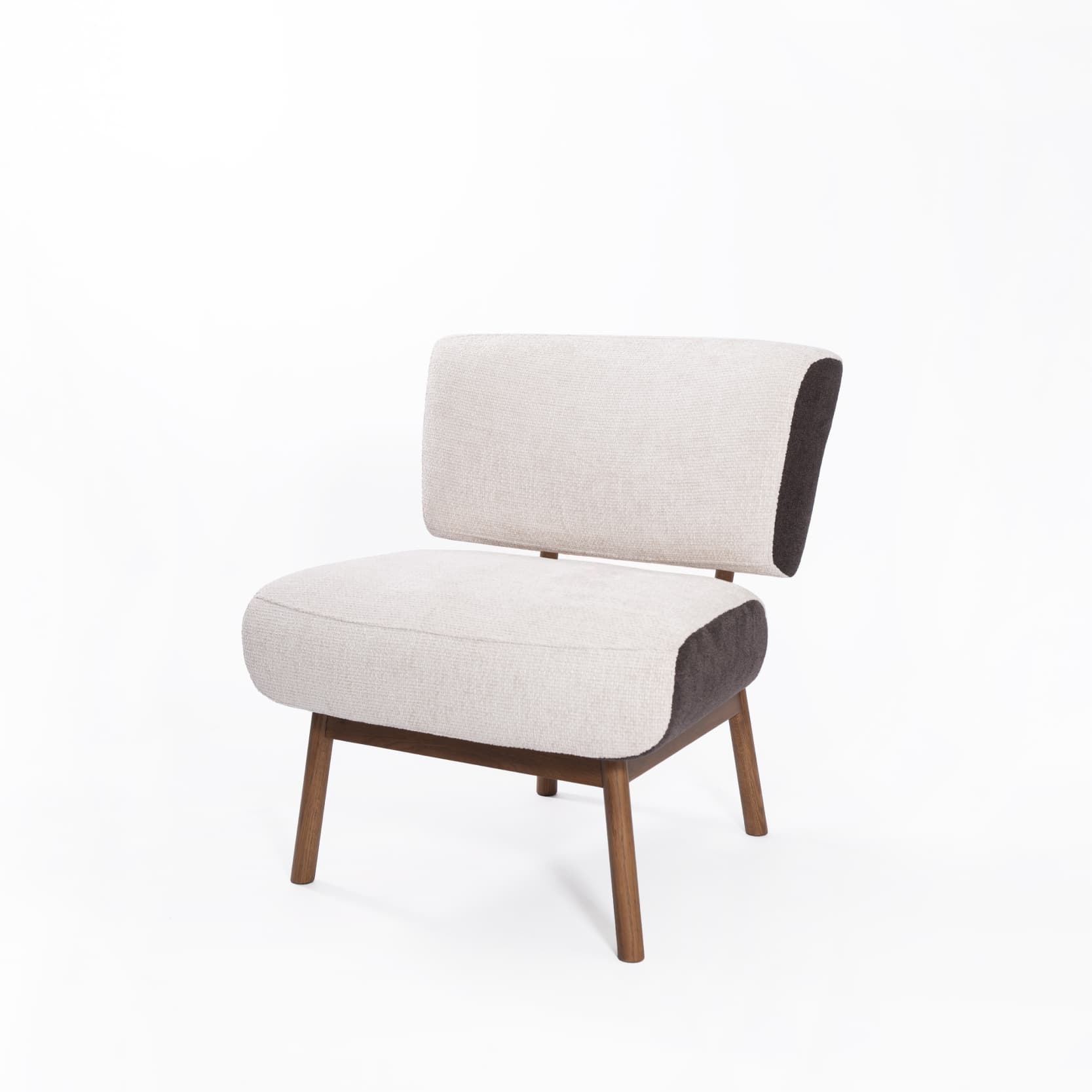 An armless lounge chair featuring a contemporary design with dual-tone upholstery. The main seating surfaces are covered in a light cream textured fabric, while the outer sides and bottom edge of the seat are finished in a contrasting dark brown fabric. The chair is supported by four slender, tapered legs made of natural wood, providing a minimalist aesthetic. — 3D model