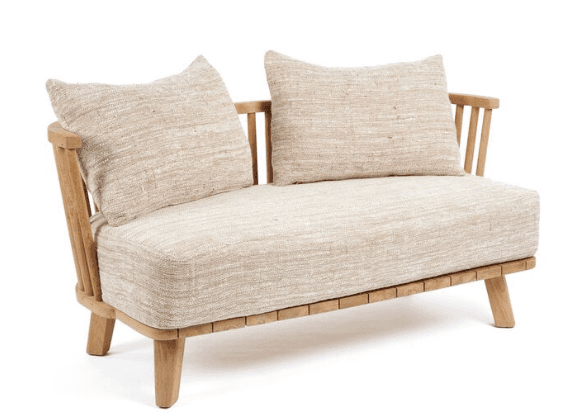 A two-seater sofa constructed with a light-colored wooden frame. The frame features slatted detailing along the base and turned spindle-style supports for the backrest. It is upholstered with a textured, light beige fabric on the seat and includes two matching throw pillows. — 3D model