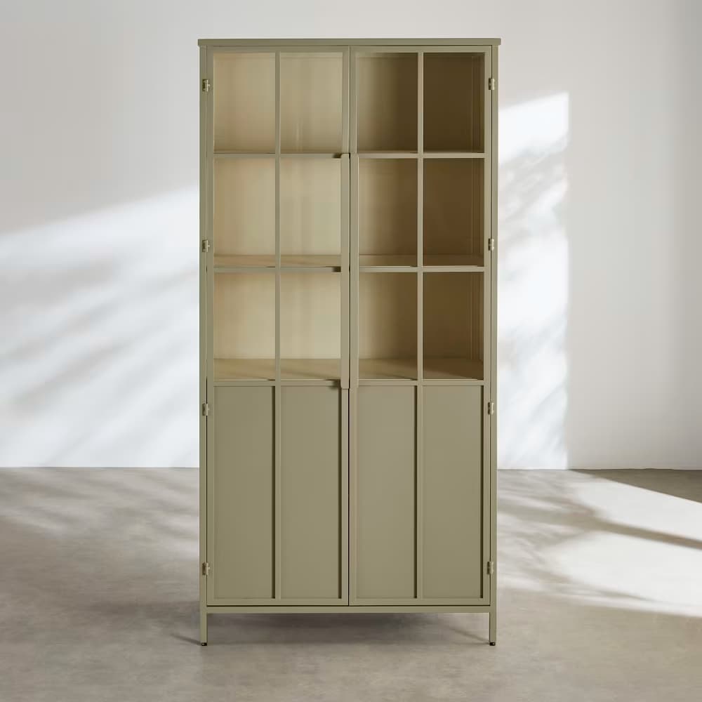A tall, rectangular display cabinet in a muted sage green finish, featuring two upper glass-paned doors for display and two lower solid doors for concealed storage, elevated on slender metal legs. — 3D model