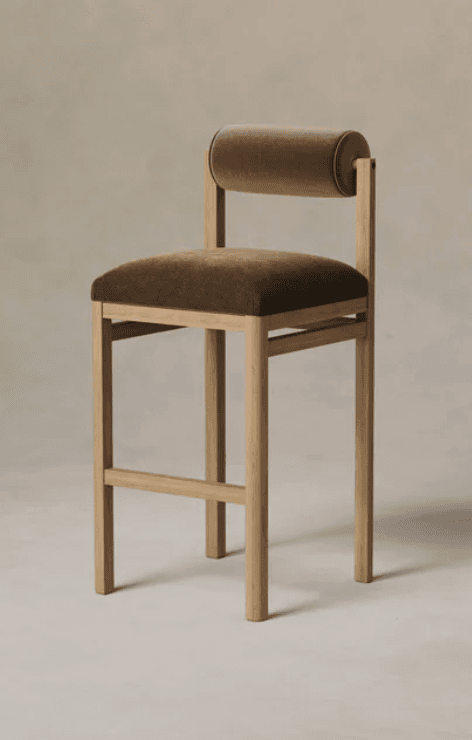 A modern bar stool with a wooden frame and upholstered seat and backrest. The seat is rectangular and upholstered, and the backrest is a cylindrical bolster also upholstered. The frame consists of four legs connected by stretchers and vertical supports for the backrest. — 3D model
