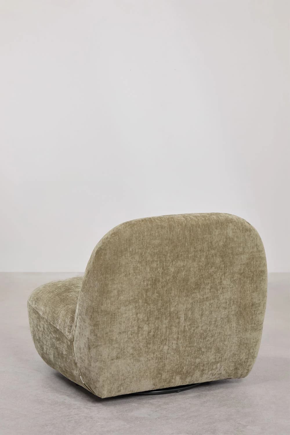 A contemporary low-profile swivel lounge chair, upholstered in a textured greenish-beige fabric. The chair features a rounded, organic silhouette with a wide, integrated back and seat, and no distinct armrests. It rests on a discreet black circular swivel base, visible at the bottom. — 3D model