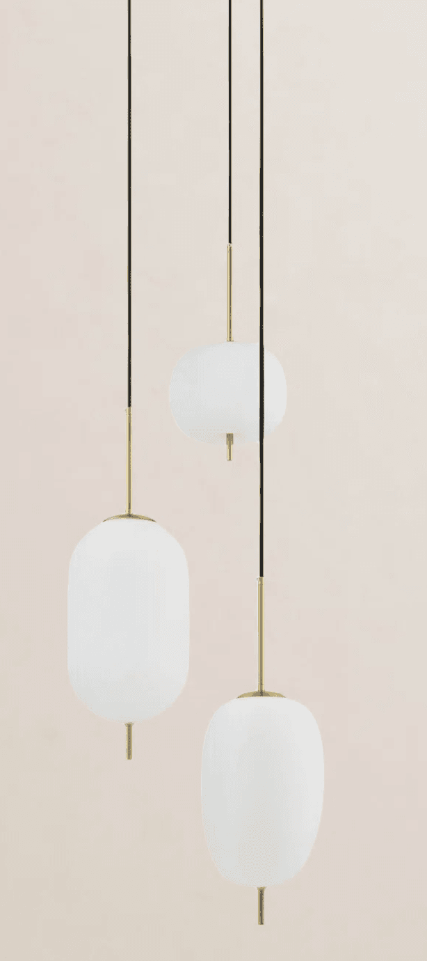 A set of three modern pendant lights featuring white opalescent glass shades of varying elongated and rounded forms, suspended by black cords with brass-finished metal accents. The design is minimalist and contemporary, providing diffused illumination. — 3D model