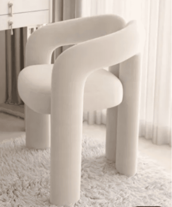 An off-white, fully upholstered accent chair featuring a distinctive sculptural and tubular design. The chair is entirely covered in a textured bouclé fabric, with thick, rounded forms defining the seat, backrest, armrests, and legs. The design is contemporary, emphasizing soft, organic curves and a monolithic appearance. — 3D model