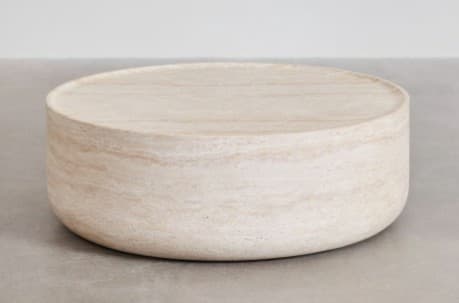 A round, low-profile coffee table constructed entirely from light-colored travertine, featuring a solid cylindrical base and a flat top surface with a subtle raised edge or lip. The natural banding of the stone is visible across the entire piece, giving it an earthy and minimalist aesthetic. — 3D model