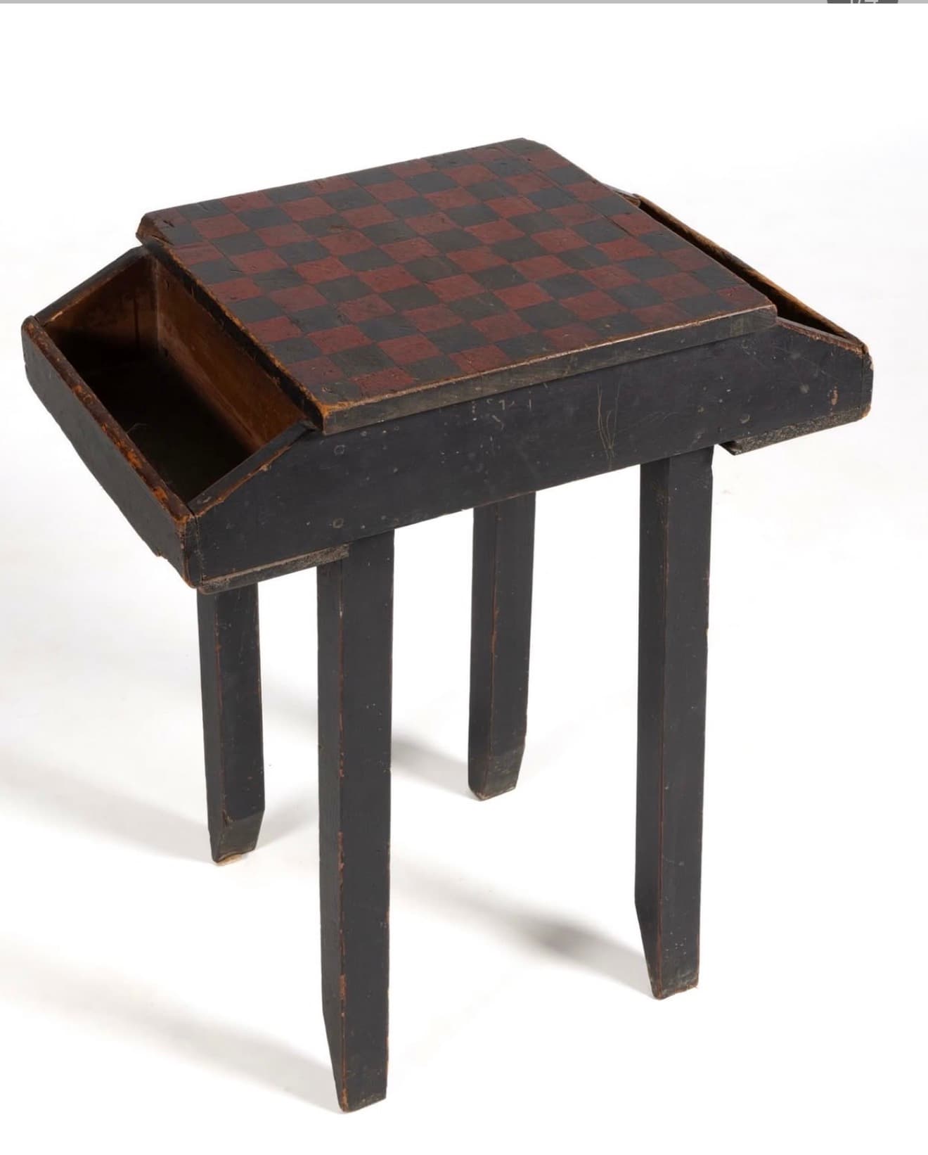 A small, rectangular wooden table featuring a hand-painted checkerboard top in black and reddish-brown, with an integrated slide-out storage compartment. The table is finished in distressed black paint and stands on four straight, square-profile legs. — 3D model